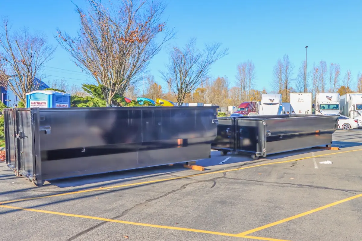 Professional dumpster rental service with roll-off container on residential driveway in Battle Creek